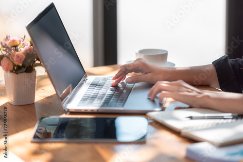 Close-up hands of woman in an office, diligently working on her laptop, Hands of a Female Specialist Working on Laptop Computer at Cozy Home