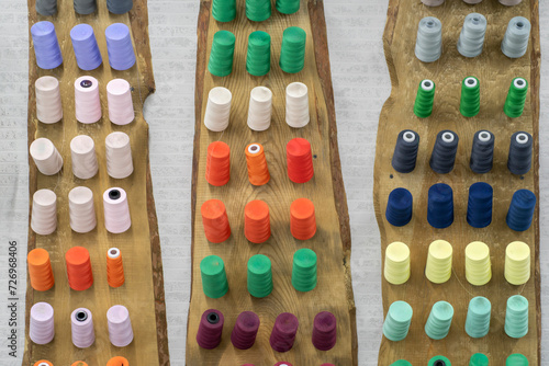 collection of colorful thread rolls on sewing manufacture