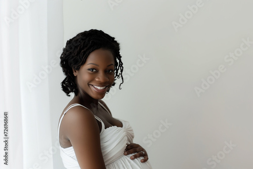 studio photo portrait of beautiful dark skin african american pregnant woman on colour background