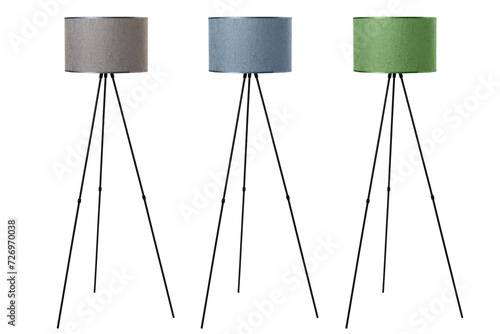 A three-legged floor lamp with a textile shade is isolated on a white background photo