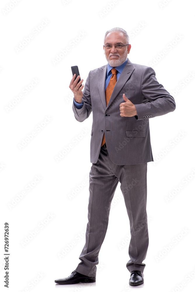 Old businessman talking by phone isolated on white