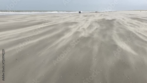 Storm blowing sand across a beach on the dutch North Sea coast photo