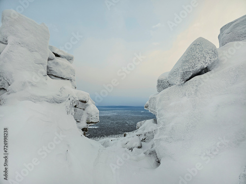 Dangerous winter gorge, a cliff between two snow rocks.