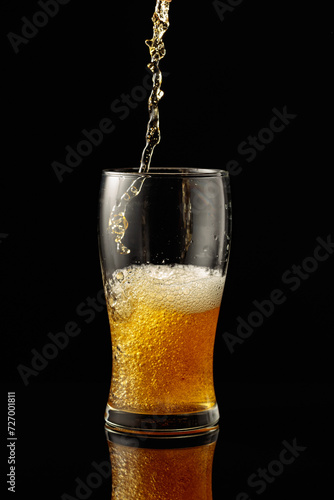 Wallpaper Mural Pouring beer into a glass on a black reflective background. Torontodigital.ca