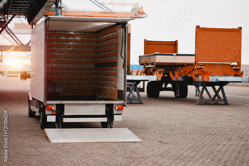 Cargo Truck In The Trade Port. Heavy-Duty Commercial Vehicle For Supply Stores Delivery. Semitrailer During Loading Of The Cargo. Commercial Vehicle For Shipping And Post Delivery	