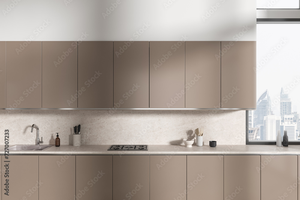 Beige home kitchen interior with cooking cabinet and panoramic window Beige home kitchen interior with cooking cabinet and panoramic window