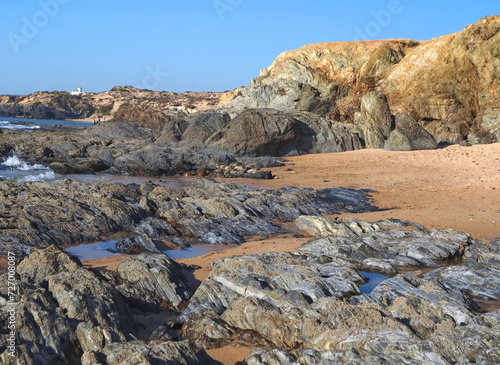Colorful slate natural rocks at the beach of Vila Nova de Milfontes in Portugal