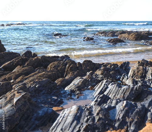 Colorful slate natural rocks at the beach of Vila Nova de Milfontes in Portugal