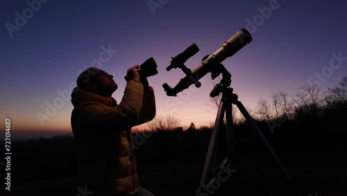 Amateur astronomer looking at the evening skies, observing planets, stars, Moon and other celestial objects with a telescope and binoculars.
 photo