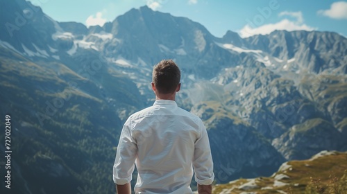 Stylish man in white classic shirt, looking at the mountains view