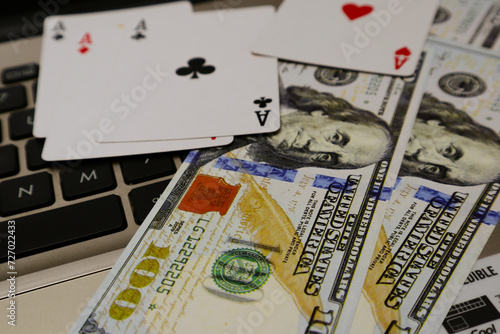 Fotografía hundred dollar bills and poker cards over keyboard background