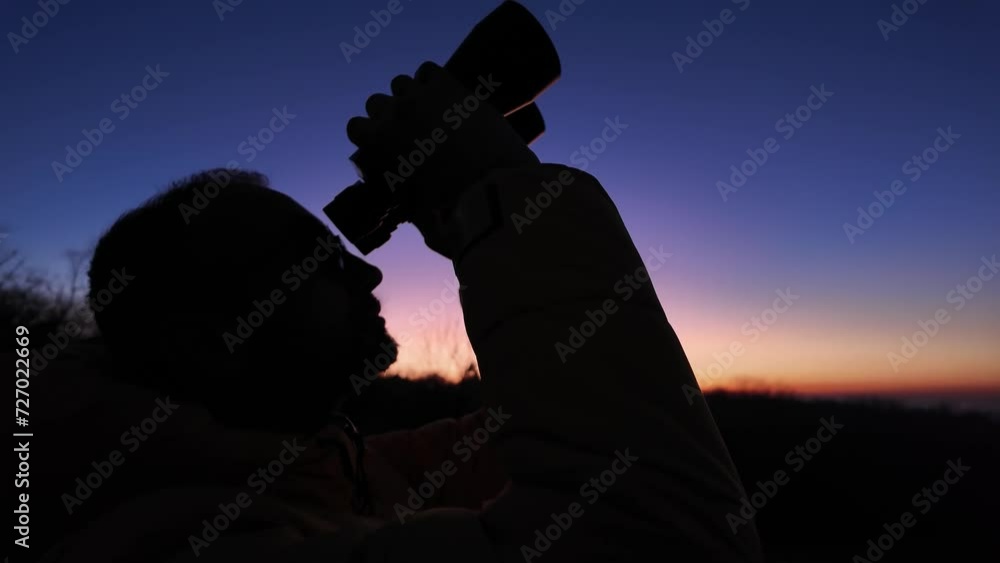 Amateur astronomer looking at the evening skies, observing planets, stars, Moon and other celestial objects with binoculars.
Amateur astronomer looking at the evening skies, observing planets, stars, Moon and other celestial objects with binoculars.