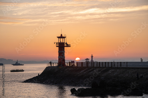 Dawn on the beach with a lighthouse view
