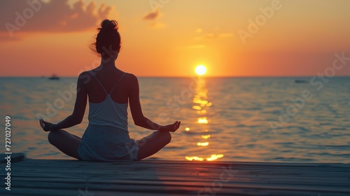A tranquil moment as a person practices yoga on a pier during a captivating ocean sunset, embodying peace and mindfulness.