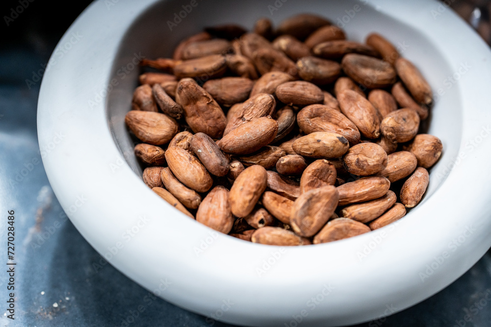 natural cocoa beans displayed on a plate natural cocoa beans displayed on a plate