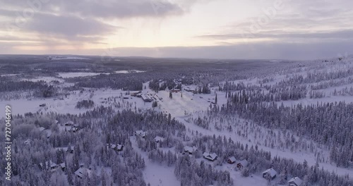 Aerial view circling toward the parking lot under the slopes of Iso-Syote, winter in Finland photo