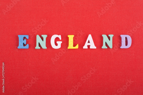 ENGLAND word on red background composed from colorful abc alphabet block wooden letters, copy space for ad text. Learning english concept.