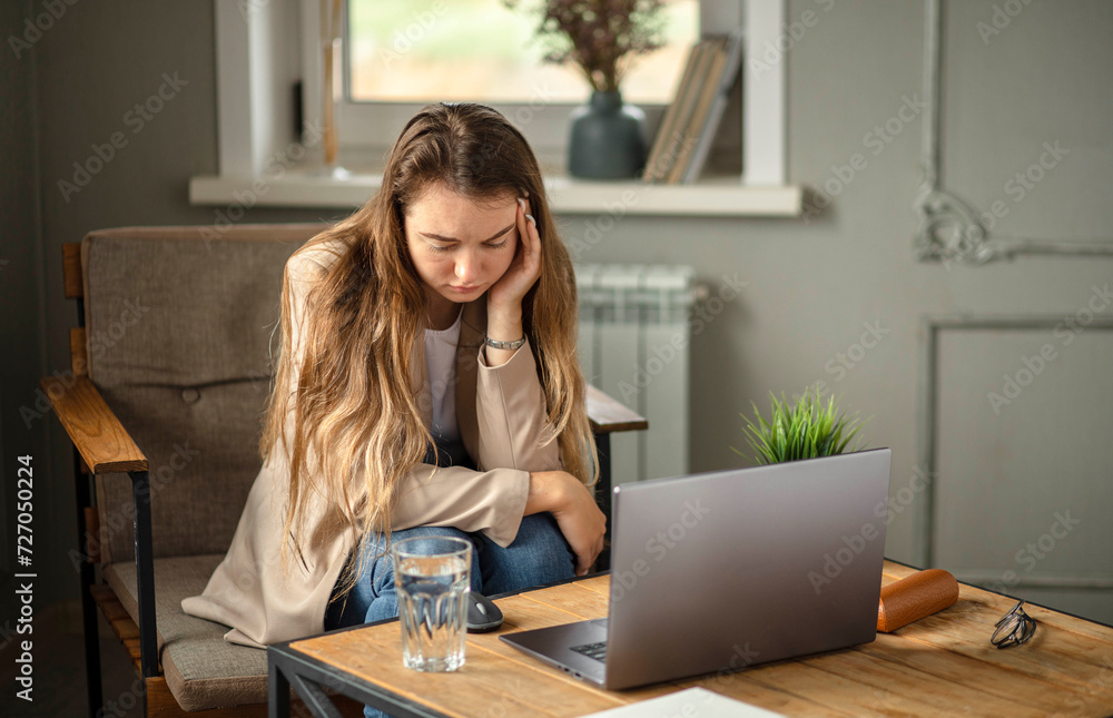 young woman, office worker, uses laptop, feels sudden burst of pain, headache, migraine. overworked accountant, feeling project pressure, stress, massages head, temple young woman, office worker, uses laptop, feels sudden burst of pain, headache, migraine. overworked accountant, feeling project pressure, stress, massages head, temple