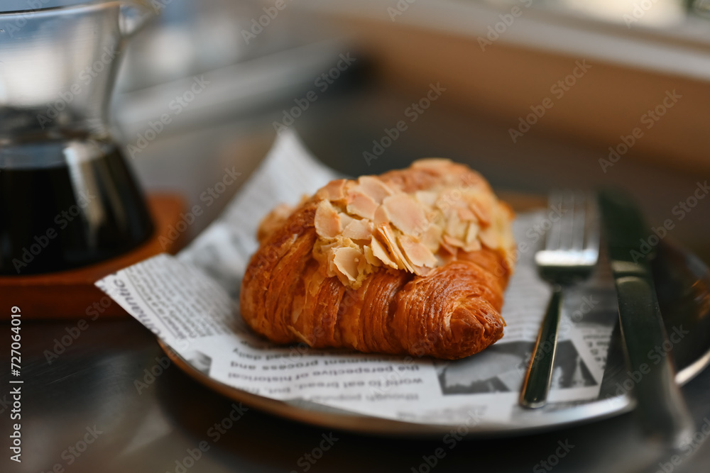Close-up of a Delicious freshly baked croissant, Served with a black coffee in the cafe Close-up of a Delicious freshly baked croissant, Served with a black coffee in the cafe