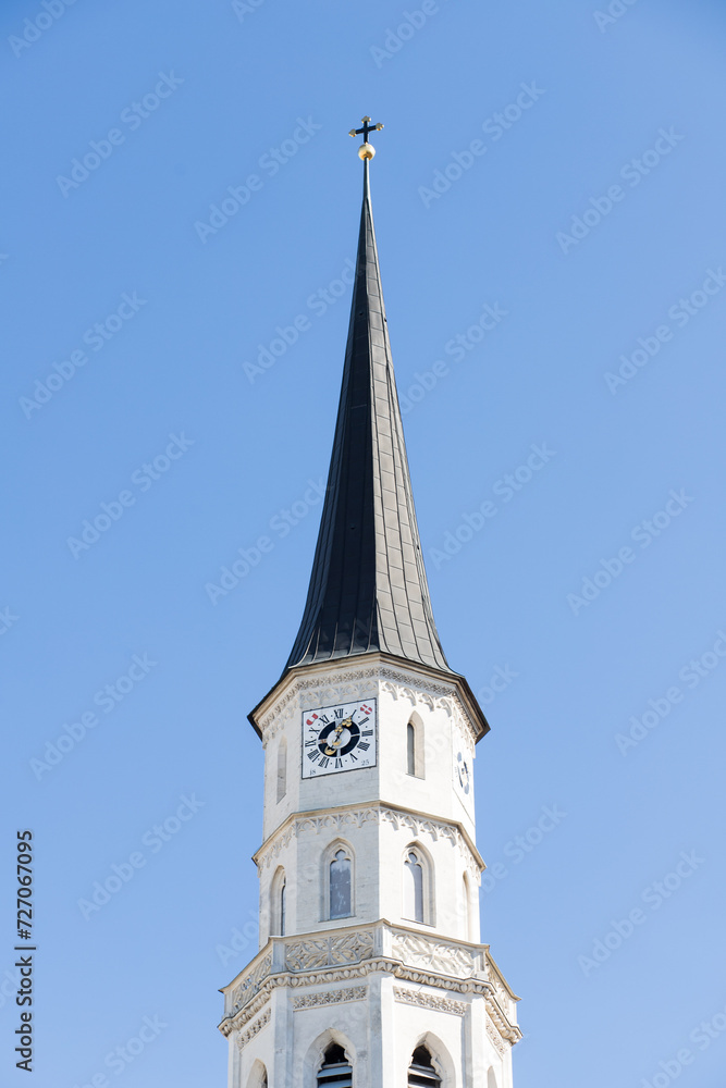 Chapel against the sky in Austria. The building of the Austrian Town Hall in the center of the capital. Clock on the tower of the building. Beautiful facade in Gothic style. Gothic architectural struc