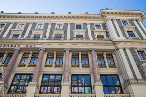 Beautiful facade of the building in unusual colors. Stylish Austrian architecture. A four-story house with a stylish facade and many windows.