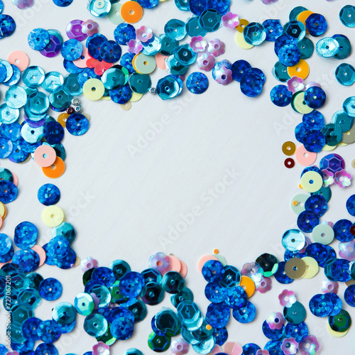 Colored and blue sequins on a white background