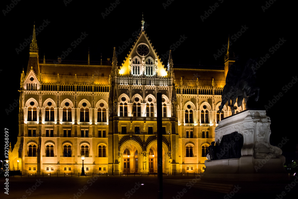 Night Parliament in Budapest. Facade of the Hungarian Parliament. Illuminated in gold color. Night Budapest. Political building. Panorama of the Parliament at night. Beautiful lighting of the building