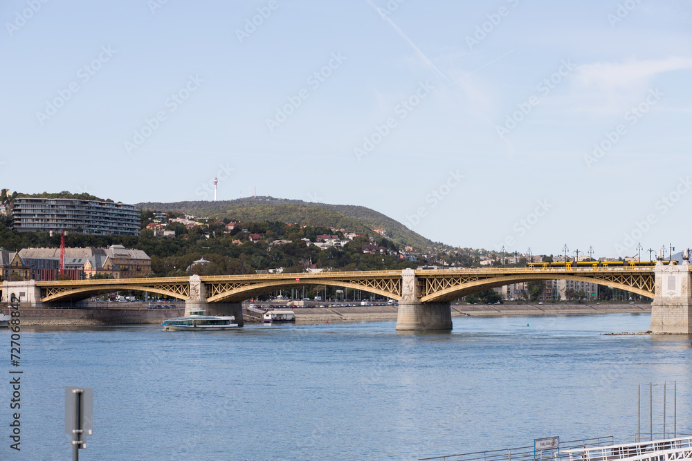 Long walking bridge over the Danube. The capital of Hungary is Budapest. Sunny weather for a walk around the big city. Long walking bridge over the Danube. The capital of Hungary is Budapest. Sunny weather for a walk around the big city.