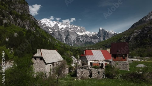 Wallpaper Mural Scenic aerial drone view of village in Theth National Park in Albania with snowy mountains and clouds in the background Torontodigital.ca