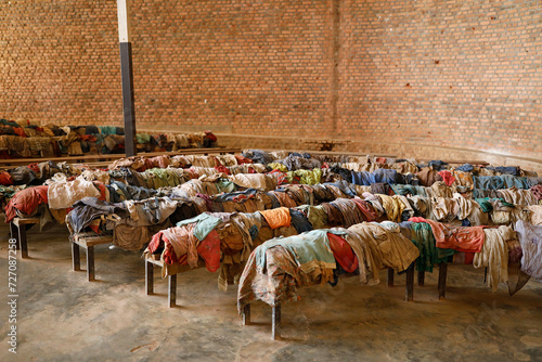 Nyamata Genocide Memorial Center, Nyamata, Rwanda. Victims' clothes on church pews photo