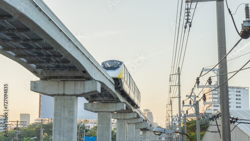 Yellow Line Train tracks ready for travel There are many people using it. that is modern Characteristics of the new bogie seat electric train without driver Suitable for use as a background image photo