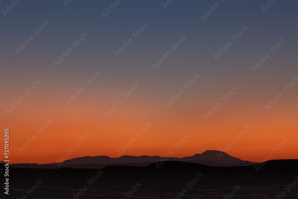 Beautiful colorful sunset sky landscape in desert with distant mountains, Egypt