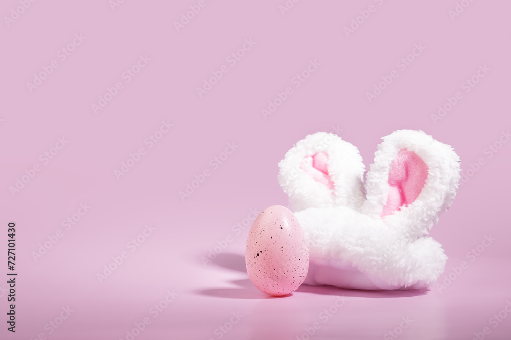 Springtime celebration, pink background, bunny ears, decorated Easter egg, joyful tradition Springtime celebration, pink background, bunny ears, decorated Easter egg, joyful tradition