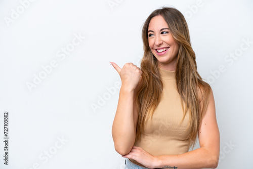 Young caucasian woman isolated on white background pointing to the side to present a product