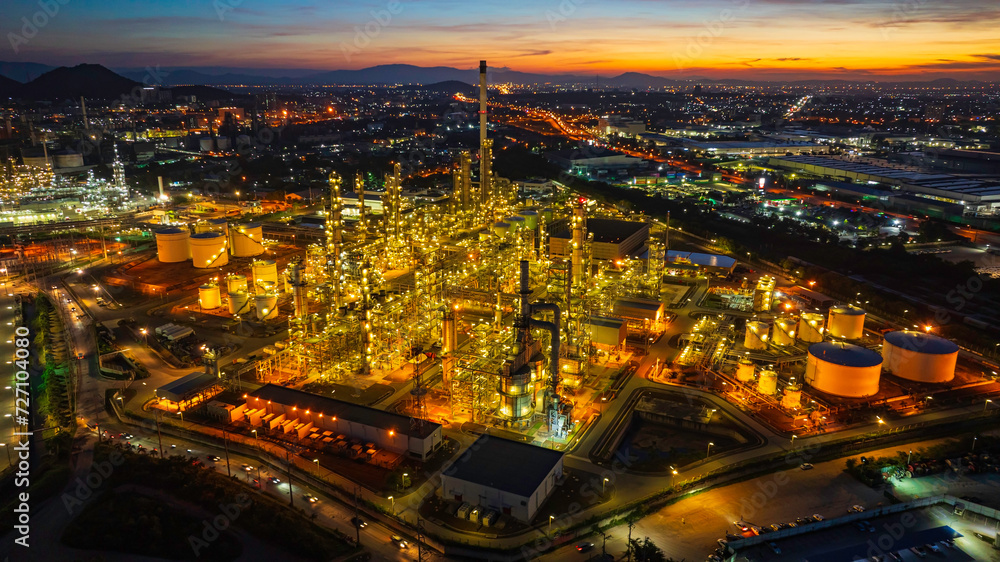 Aerial view of the morning of the oil refinery from the drone of the tower of the Petrochemistry industry in the oil​ and​ gas​ ​industry with​ cloud​ sun orange​