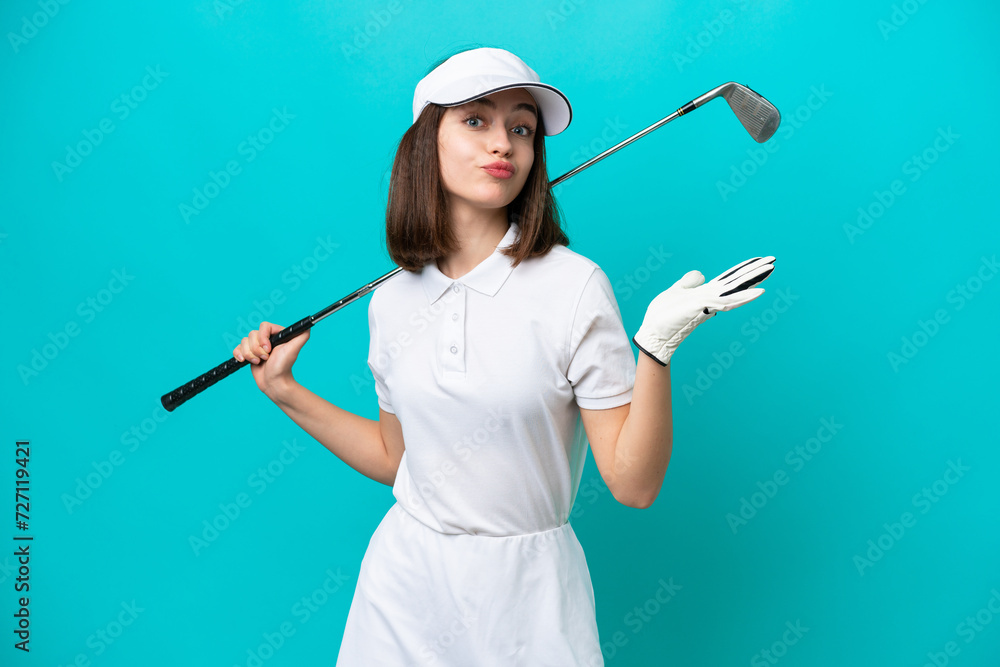 Young Ukrainian golfer player woman isolated on blue background having doubts while raising hands Young Ukrainian golfer player woman isolated on blue background having doubts while raising hands