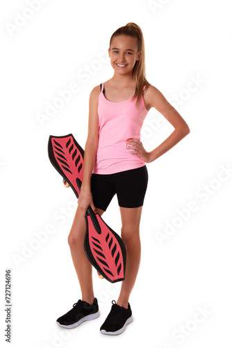 Cheerful sporty teen girl standing on wave board with hands up,isolated on white background
