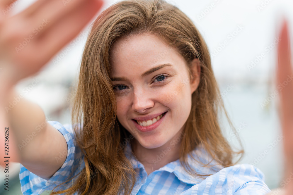 Young redhead woman at outdoors With happy expression Young redhead woman at outdoors With happy expression