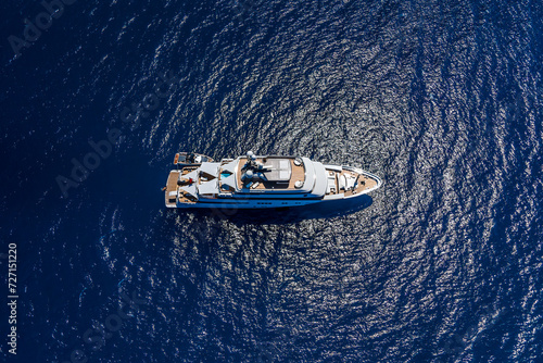 Aerial top view made by drone of big yacht in the blue sea. © Paopano
