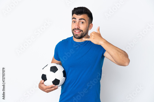 Handsome young football player man over isolated wall making phone gesture. Call me back sign © luismolinero
