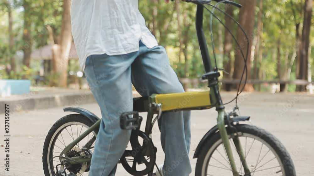 Beautiful happy woman in yellow coat riding bicycle in autumn park. Autumn fashion. Lifestyle. Relax, nature concept. Beautiful happy woman in yellow coat riding bicycle in autumn park. Autumn fashion. Lifestyle. Relax, nature concept.