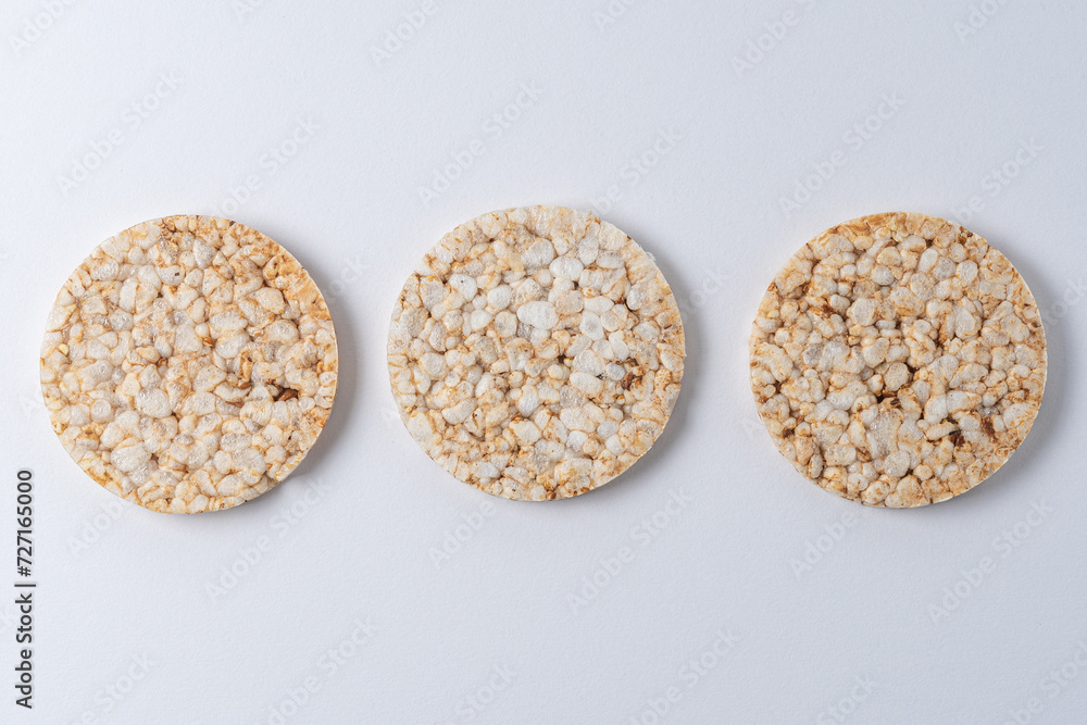 Pile of three rice cakes on white backdrop. Food background. Pile of three rice cakes on white backdrop. Food background.