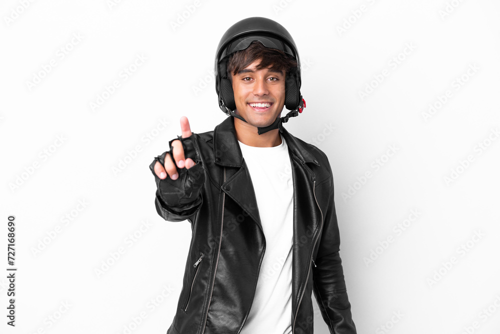 Young man with a motorcycle helmet isolated on white background showing and lifting a finger Young man with a motorcycle helmet isolated on white background showing and lifting a finger