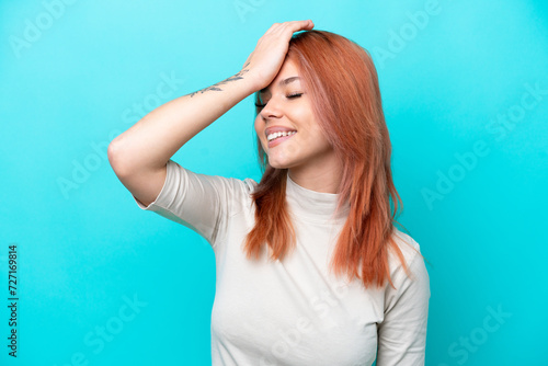 Young Russian woman isolated on blue background has realized something and intending the solution