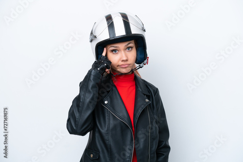 Young Russian girl with a motorcycle helmet isolated on white background thinking an idea