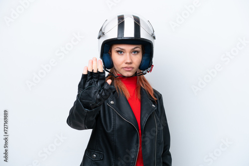 Young Russian girl with a motorcycle helmet isolated on white background making stop gesture
