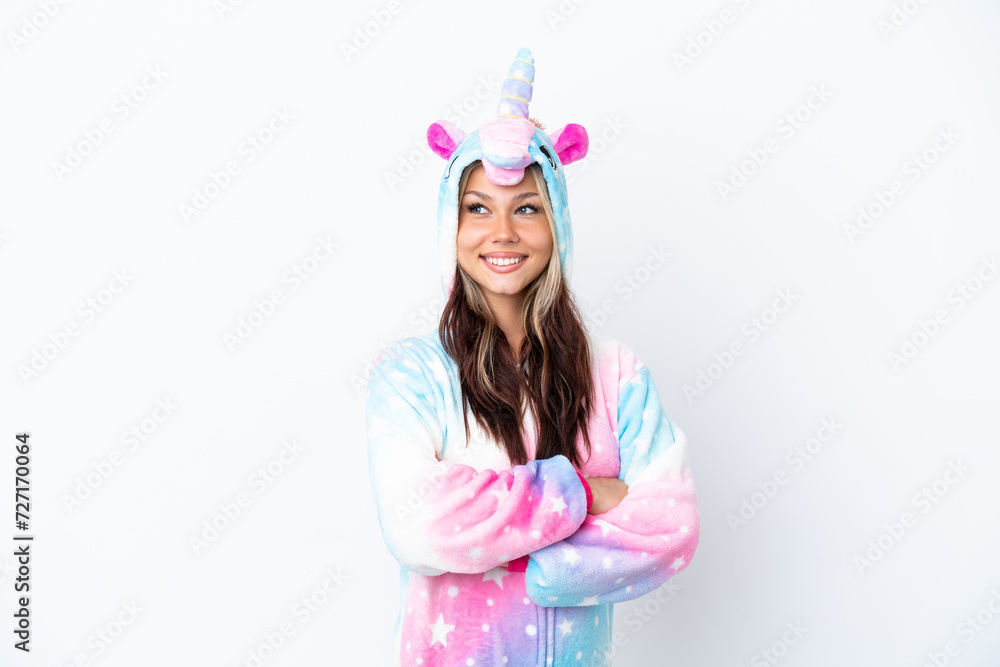 Young Russian woman wearing a unicorn pajama isolated on white background with arms crossed and happy Young Russian woman wearing a unicorn pajama isolated on white background with arms crossed and happy