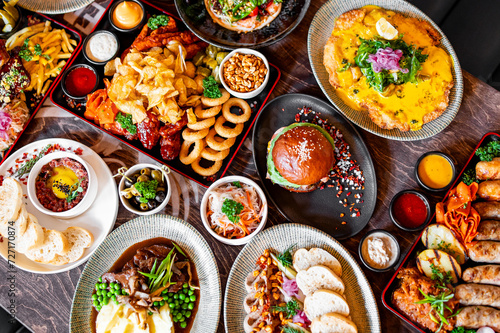 variety of restaurant food dishes on table. top view. © pavel siamionov