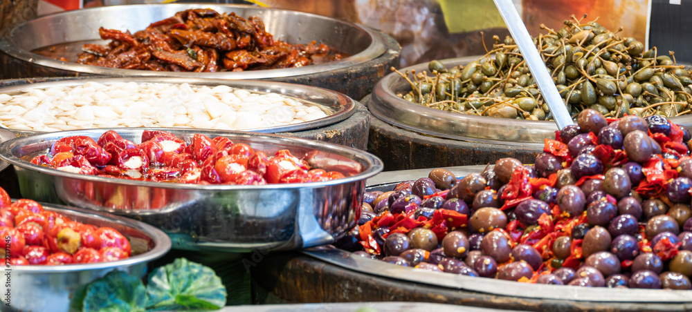 Food stall at a market in Catania, Sicily. Tomatoes, olives, spring onions and other delicacies