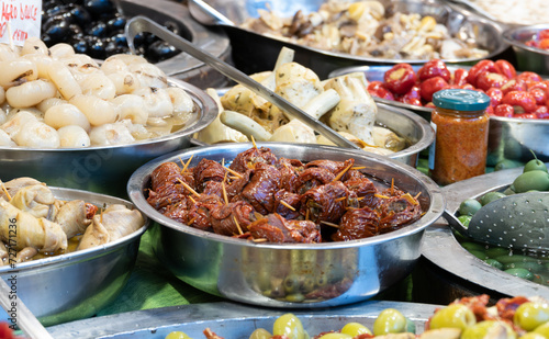 Food stall at a market in Catania, Sicily. Tomatoes, olives, spring onions and other delicacies